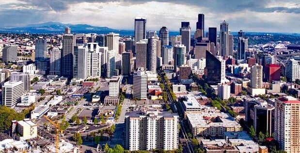 The photo depicts a view of Seattle, Washington, taken from the Space Needle.