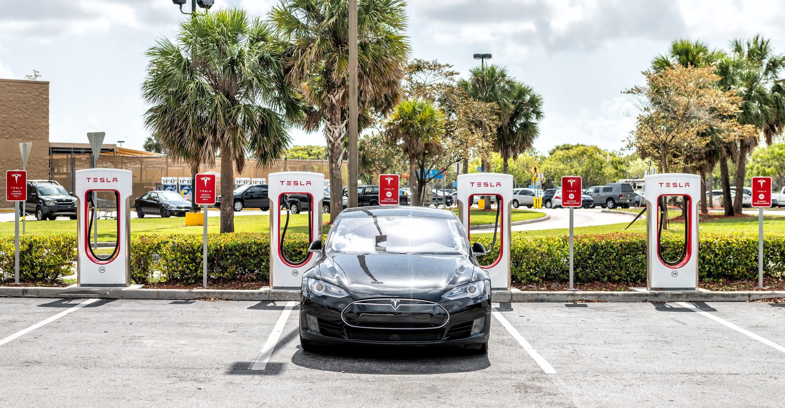 Electric car being charged at Tesla Super Charging station