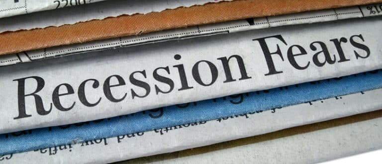The image shows a bundle of newspapers, and one features the headline "Recession Fears."