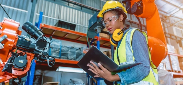 Woman Engineer programing robotic welding machine